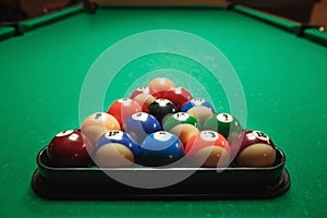 Two cues and pyramid on a billiard table.