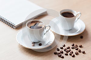 Two cup of turkish coffee close-up on a wooden background, coffee beans. Pleasant morning and cheerfulness