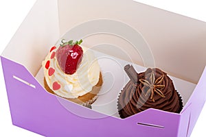 Two Cupcakes are in the Delivery Box over white background