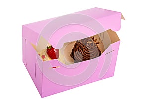 Two Cupcakes are in the Delivery Box over white background