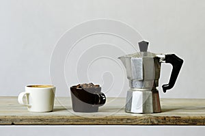 Two cups of coffee and beans and percolator photo