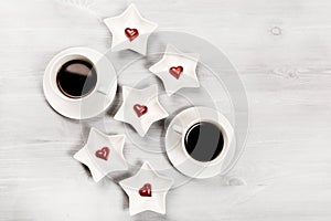 Two cups of coffee and heart shaped sweets