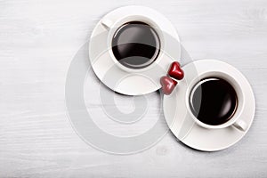 Two cups of coffee and heart shaped sweets