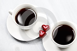 Two cups of coffee and heart shaped sweets