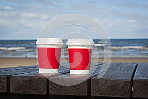 Two cups of coffee on the seacoast beach for a couple in love