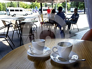 Two cups of coffee on a table in a cafe