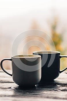 Two cups with coffee on the wooden table