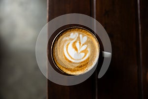 Two Cups of hot cappuccino on wooden desk background