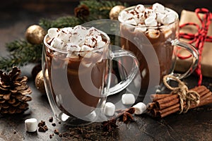 Two cups of hot chocolate with holiday background