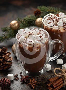 Two cups of hot chocolate with holiday background