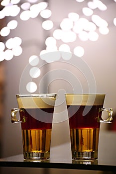 Two cups of the layered cocktail Blabarsputte, consisting of Licor 43, blueberry soup, and cream photo