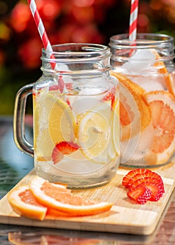 Two cups of lemonade with grapefruit and strawberry