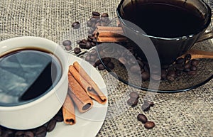 Two cups of morning fragrant coffee on a patterned wooden table