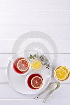 Two cups of red fruit and herbal tea with lemon slice