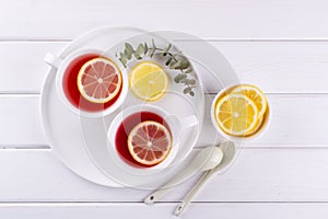 Two cups of red fruit and herbal tea with lemon slice