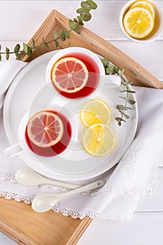 Two cups of red fruit and herbal tea with lemon slice,