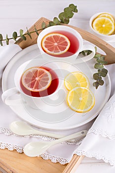 Two cups of red fruit and herbal tea with lemon slice