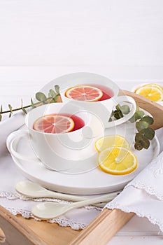 Two cups of red fruit and herbal tea with lemon slice,
