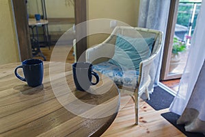 Two cups on a rustic hotel table