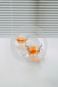Two cups of tea over white background