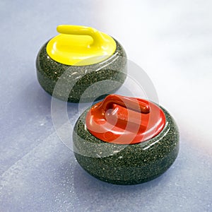 Two curling stone on Ice