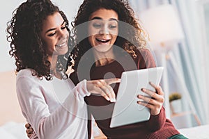 Two curly sisters feeling memorable while remembering childhood