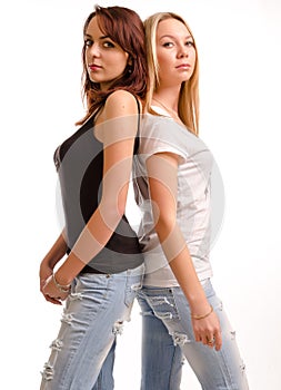 Two curvy young woman standing back