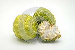 Two custard apples and one half custard apple, isolated on background.