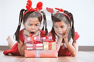 Two cute asian child girls surprise with gift boxes
