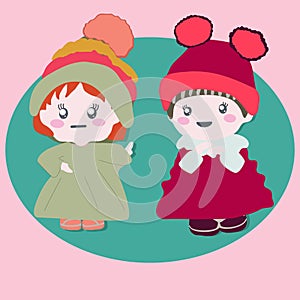 Two cute baby dolls wearing winter outfits
