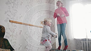 Two cute children baby girls playing and having fun in the kids room.