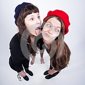 Two cute girls having fun and making funny faces