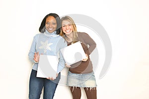 Two cute girls holding blank signs