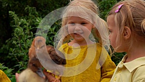 two cute girls look at chicks and smile