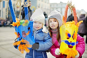 Two cute girls wearing frightening masks during the celebration of Uzgavenes, a Lithuanian annual folk festival taking place seven