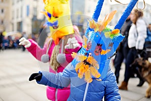 Two cute girls wearing frightening masks during the celebration of Uzgavenes, a Lithuanian annual folk festival taking place seven