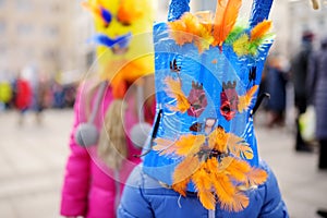 Two cute girls wearing frightening masks during the celebration of Uzgavenes, a Lithuanian annual folk festival taking place seven