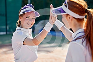 Two Cute Happy Women Playing Tennis One to One. Girlfriends Doing Sport Together