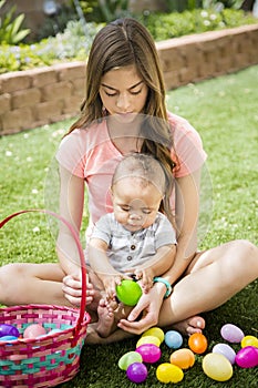 Two cute kids collecting eggs on an Easter Egg hunt outdoors