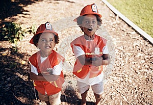 Two cute little african american boys having fun while playing outside in the backyard pretending to be firemen. Two
