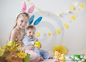 Two cute little children boy and girl wearing bunny ears