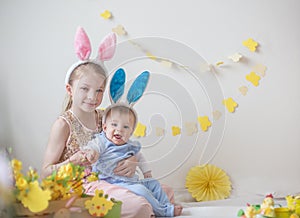Two cute little children boy and girl wearing bunny ears