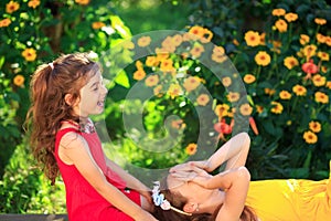 Two Cute little girls embracing and smiling at the  countryside. Happy kids spending time  outdoors