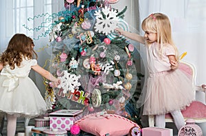 Two cute little girls in a festive New Year`s atmosphere