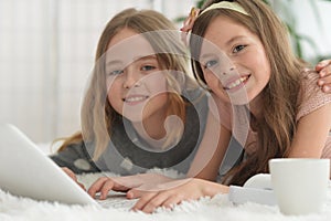 Two cute little girls with a laptop