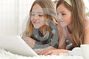 Two cute little girls with a laptop