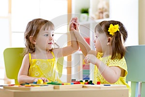 Two cute little girls playing together in daycare