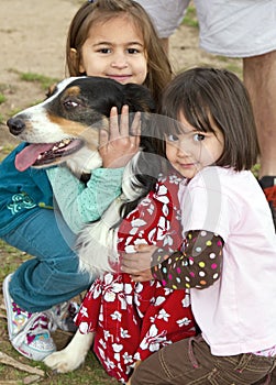 Two cute little girls and a rescue agency dog