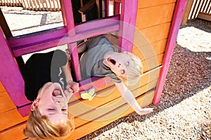 Two Cute Little Kids Playing Outside in a Club House at a Playground, Making Funny Faces