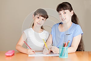 Two Cute Little School Girls are Drawing